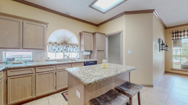 7640 Merion Dr, Beaumont, TX 77707 - kitchen with ornamental molding, light tile patterned floors, dishwasher, a center island, and light stone countertops