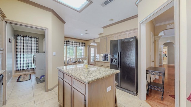 7640 Merion Dr, Beaumont, TX 77707 - kitchen with black fridge with ice dispenser, arched walkways, crown molding, a center island, and light tile patterned flooring
