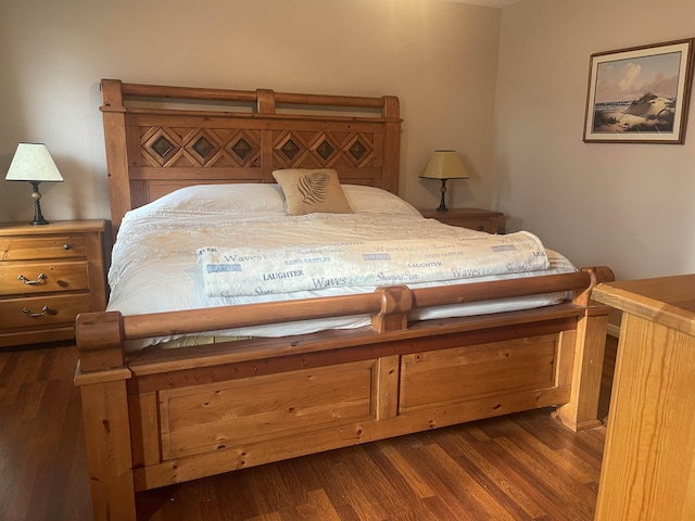 bedroom with dark hardwood / wood-style flooring