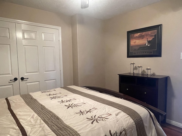 bedroom featuring ceiling fan, a closet, and hardwood / wood-style flooring