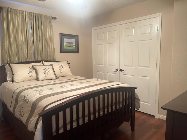 bedroom featuring ceiling fan, a closet, and dark wood-type flooring