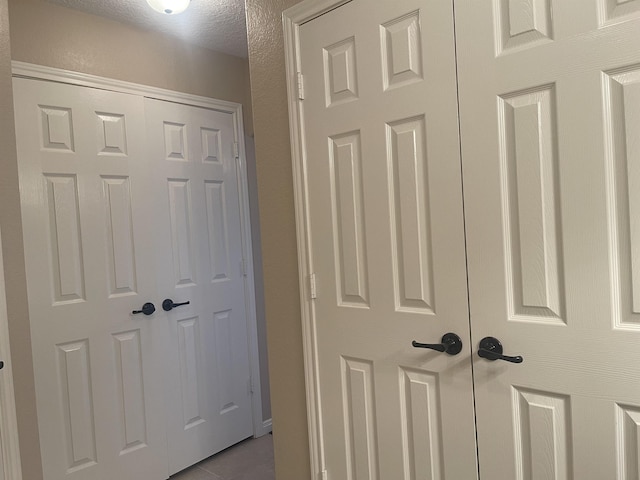 hallway with light tile patterned flooring