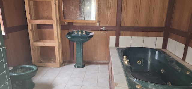 bathroom with tile patterned flooring, toilet, and a bath