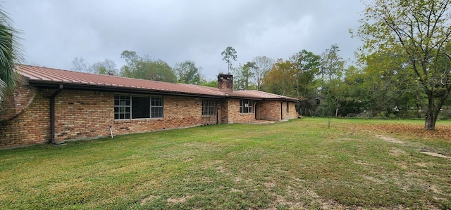 back of house with a lawn