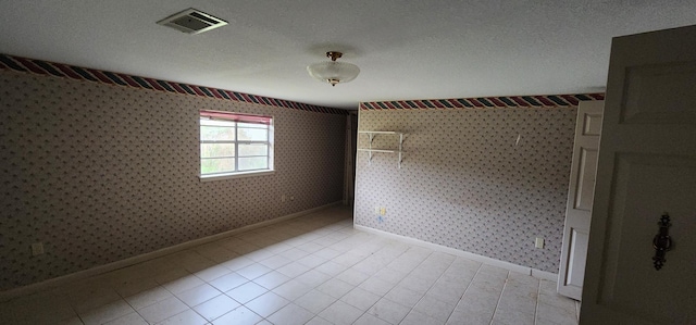 unfurnished bedroom with light tile patterned floors and a textured ceiling