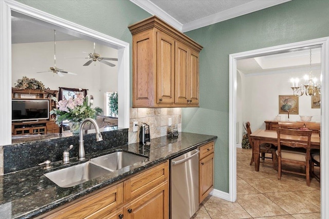 kitchen featuring dark stone counters, sink, stainless steel dishwasher, light tile patterned floors, and ornamental molding