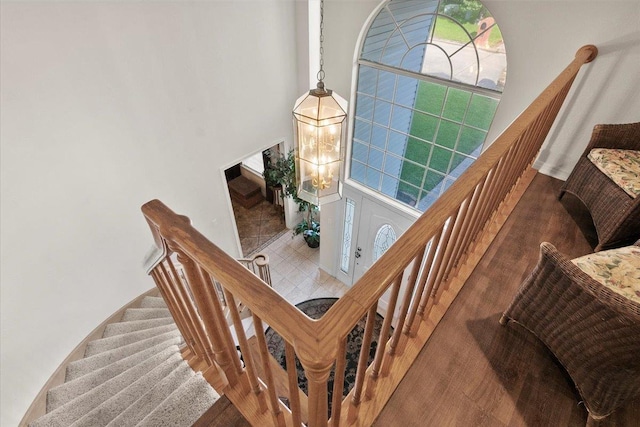 staircase featuring an inviting chandelier