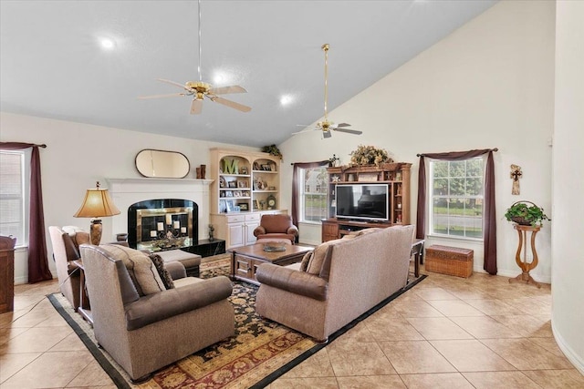 tiled living room with high vaulted ceiling and a healthy amount of sunlight