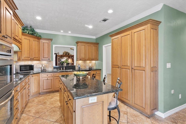 kitchen with tasteful backsplash, a center island, stainless steel appliances, and ornamental molding