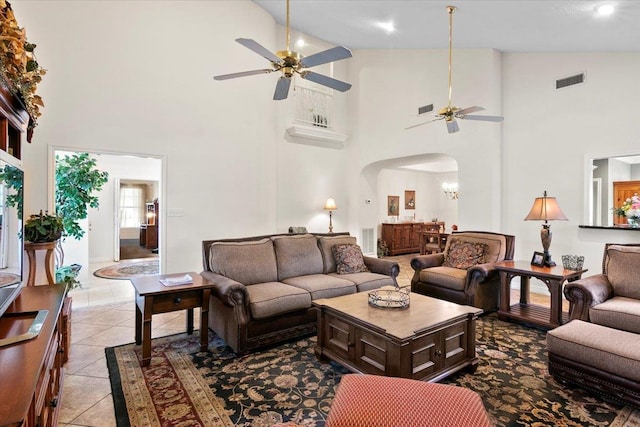 tiled living room with high vaulted ceiling and ceiling fan