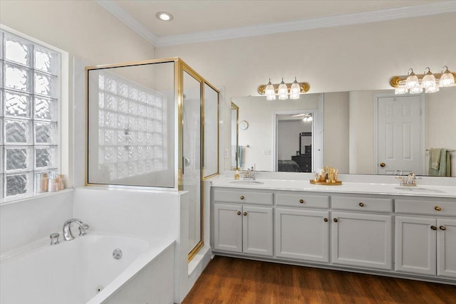 bathroom featuring vanity, crown molding, plus walk in shower, and wood-type flooring