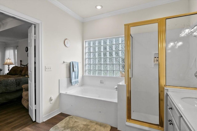 bathroom featuring hardwood / wood-style floors, vanity, ornamental molding, and independent shower and bath