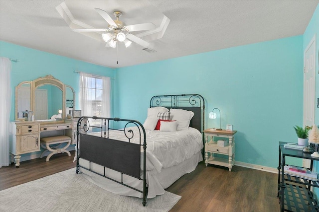 bedroom featuring a textured ceiling, dark hardwood / wood-style flooring, and ceiling fan