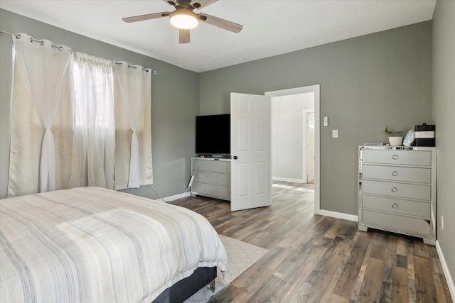 bedroom with dark hardwood / wood-style floors and ceiling fan