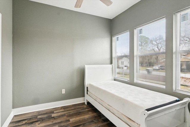 bedroom featuring dark hardwood / wood-style floors and ceiling fan