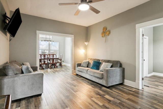 living room featuring wood-type flooring and ceiling fan