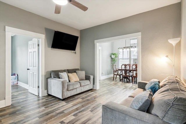 living room featuring hardwood / wood-style floors and ceiling fan