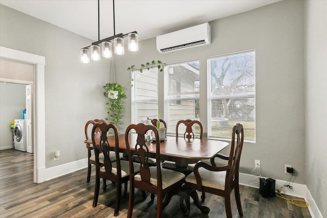 dining area featuring dark hardwood / wood-style floors, a healthy amount of sunlight, a wall mounted air conditioner, and washer / clothes dryer