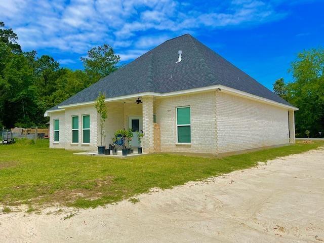 rear view of house featuring a lawn