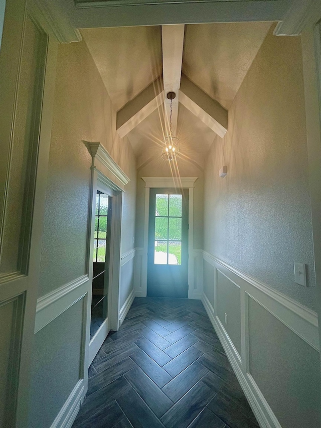 doorway to outside with dark parquet flooring and an inviting chandelier