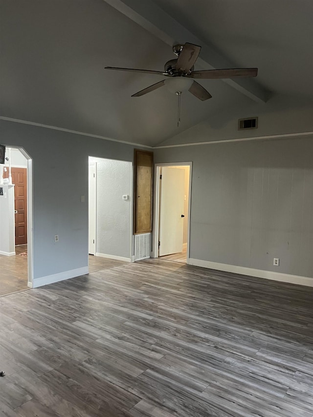 empty room featuring ceiling fan, lofted ceiling with beams, and hardwood / wood-style floors