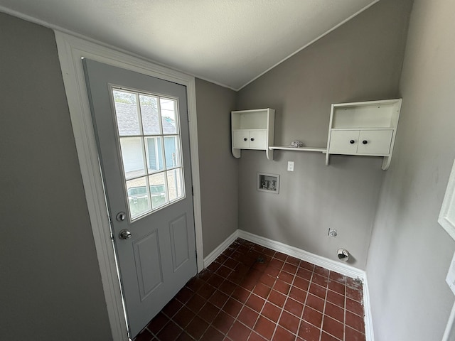 washroom featuring dark tile patterned flooring, laundry area, baseboards, and hookup for a washing machine
