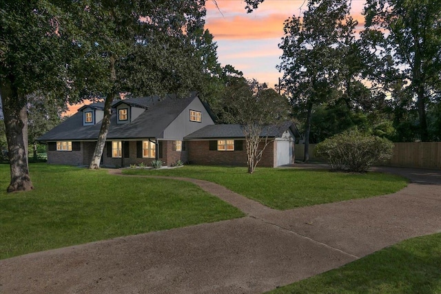 view of front of property with a yard and a garage