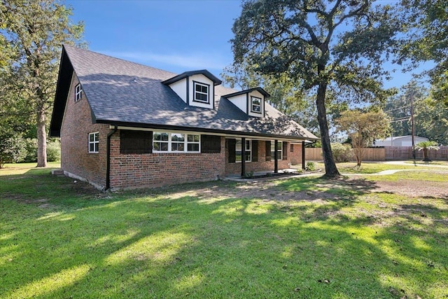 cape cod house with a front yard