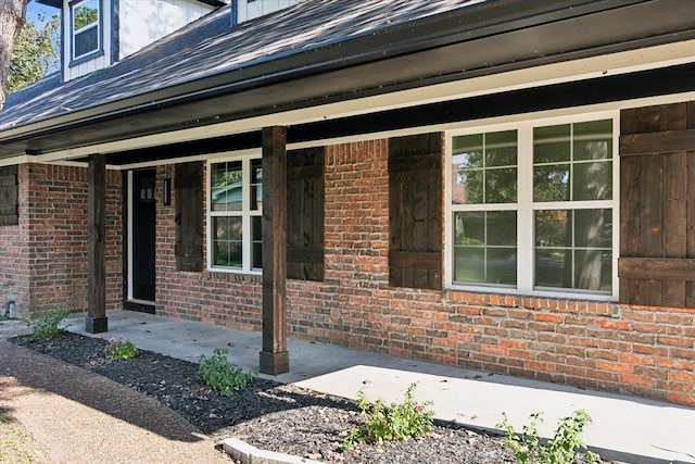 view of exterior entry with covered porch