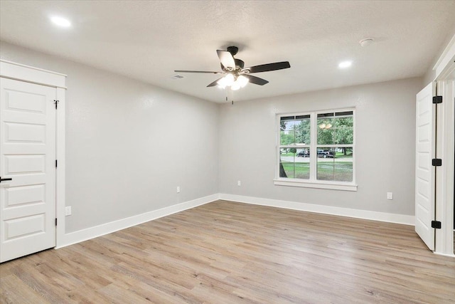 unfurnished room with light hardwood / wood-style flooring and ceiling fan