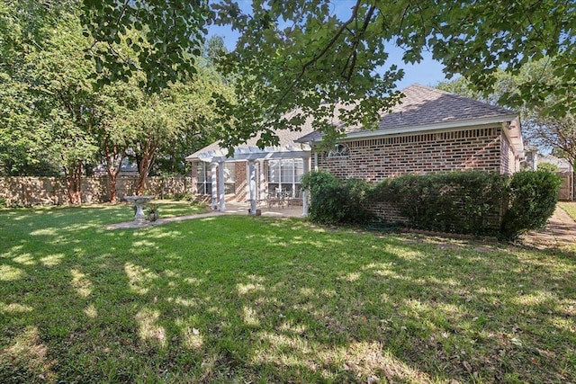 view of yard with fence, a pergola, and a patio