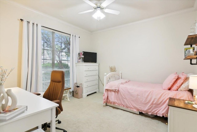 carpeted bedroom featuring crown molding and a ceiling fan