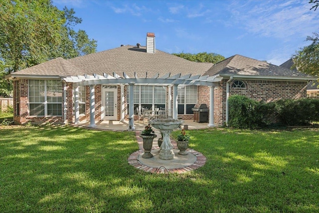 rear view of property with a pergola, a lawn, brick siding, and a patio