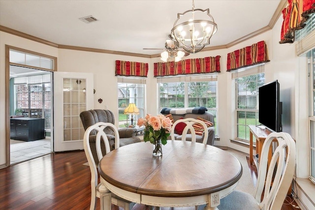 dining area with wood finished floors, visible vents, a chandelier, and a healthy amount of sunlight