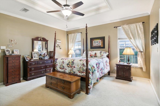 bedroom with a tray ceiling, light carpet, visible vents, and multiple windows