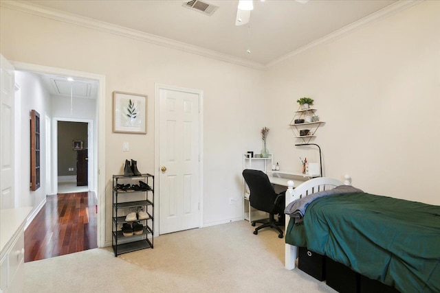 bedroom with attic access, carpet, baseboards, ornamental molding, and visible vents