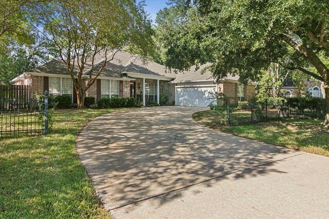 single story home featuring concrete driveway, a front lawn, brick siding, and a garage