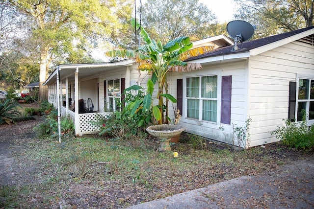 view of property exterior with a porch