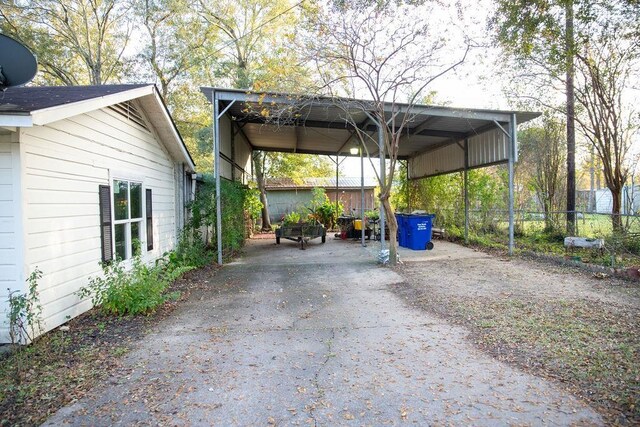 view of parking / parking lot featuring a carport