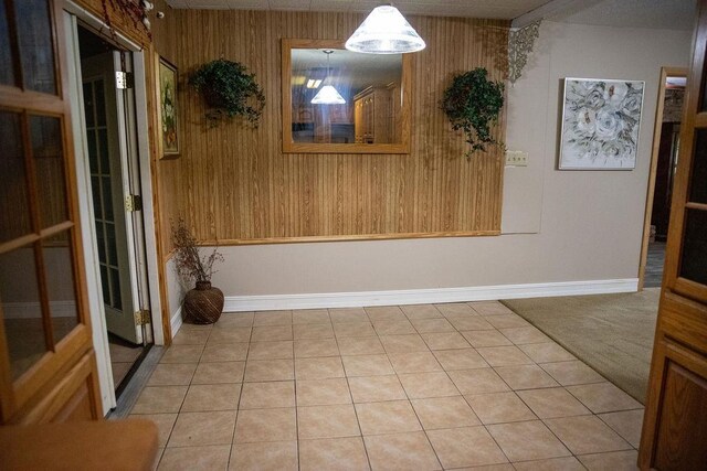 tiled empty room with wood walls