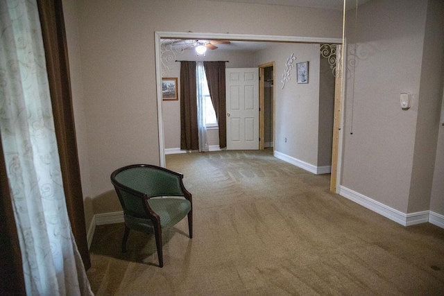 unfurnished room featuring ceiling fan and carpet