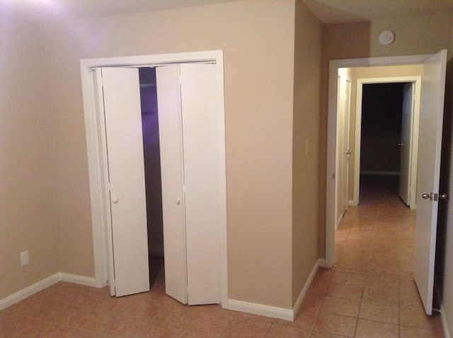 hall with light tile patterned floors