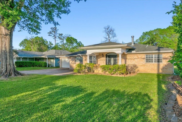 single story home with a garage and a front lawn