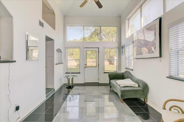 interior space with ceiling fan