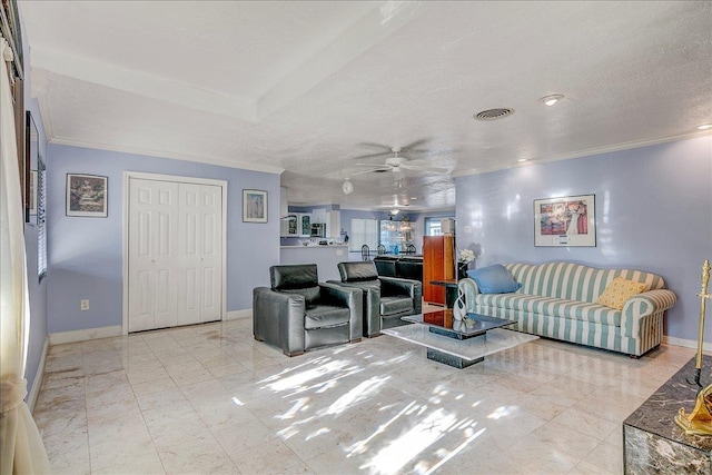 living room with a textured ceiling, ceiling fan, and crown molding