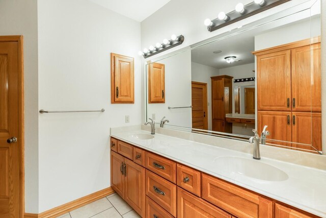 114 Holmes Rd, Lumberton, TX 77657 - bathroom featuring double vanity, tile patterned flooring, and baseboards