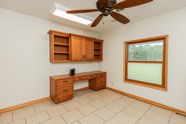114 Holmes Rd, Lumberton, TX 77657 - unfurnished office with baseboards, built in desk, ceiling fan, and light tile patterned floors