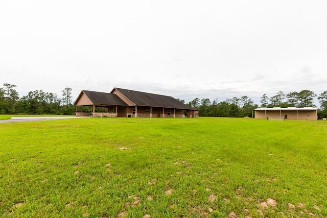 114 Holmes Rd, Lumberton, TX 77657 - view of grassy yard featuring a carport and driveway