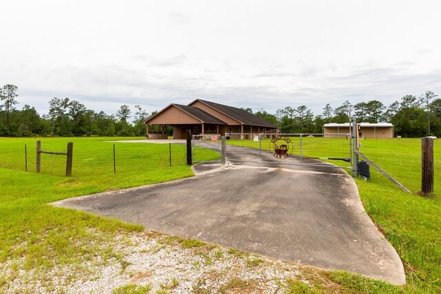 114 Holmes Rd, Lumberton, TX 77657 - view of front facade with asphalt driveway and a gate