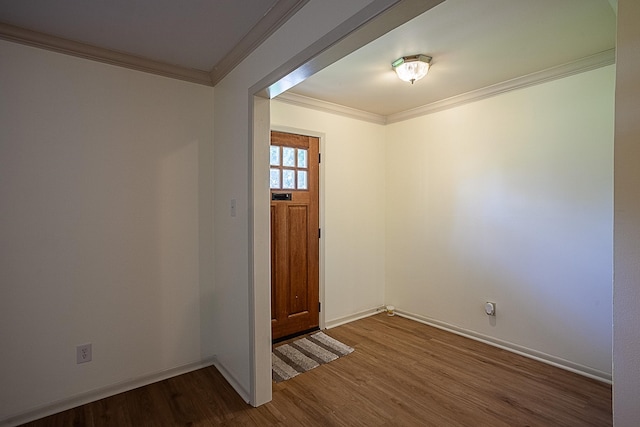 foyer featuring crown molding and dark wood-type flooring